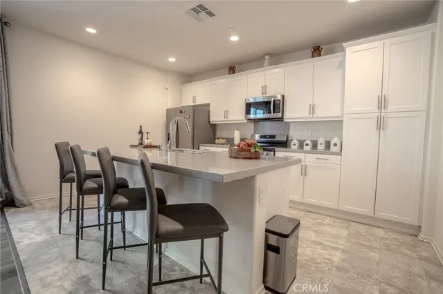 a kitchen with stainless steel appliances granite countertop a sink stove and cabinets