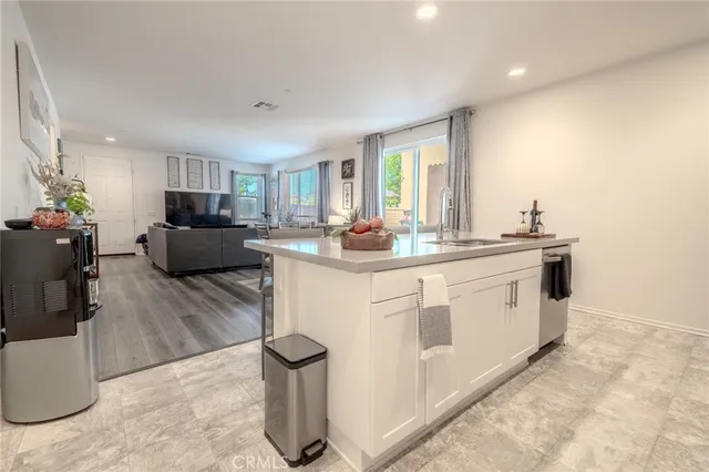 a kitchen with white cabinets stainless steel appliances and sink