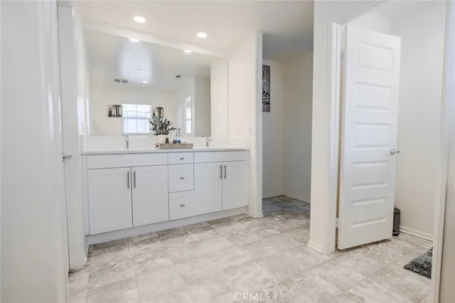 a bathroom with a sink a vanity and a mirror