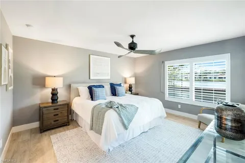 a spacious bedroom with a bed and a window