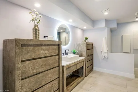 a spacious bathroom with a double vanity sink and a mirror