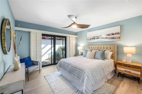 a bedroom with a large bed and a chandelier