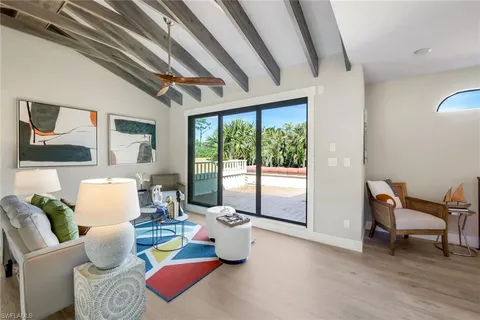 a living room with furniture and a floor to ceiling window