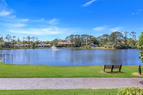 a view of a lake with houses in the back