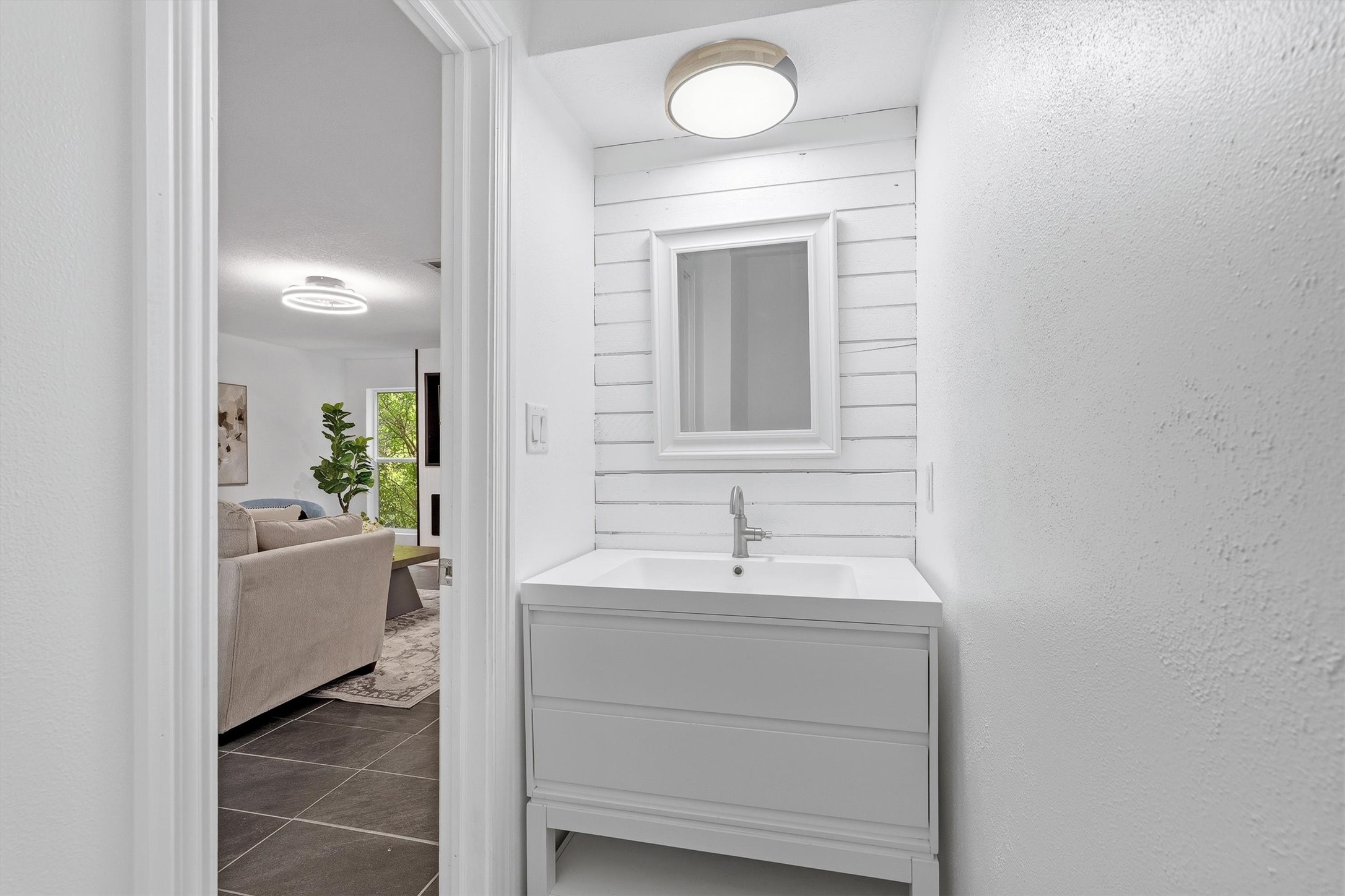 1011 Hamblen Road, Unit 306 Houston, TX 77339 - Photo 15 of 38 Just off the living area, a stylish powder room features a shiplap accent wall and a sleek vanity, a perfect little touch for guests without them having to venture too far.