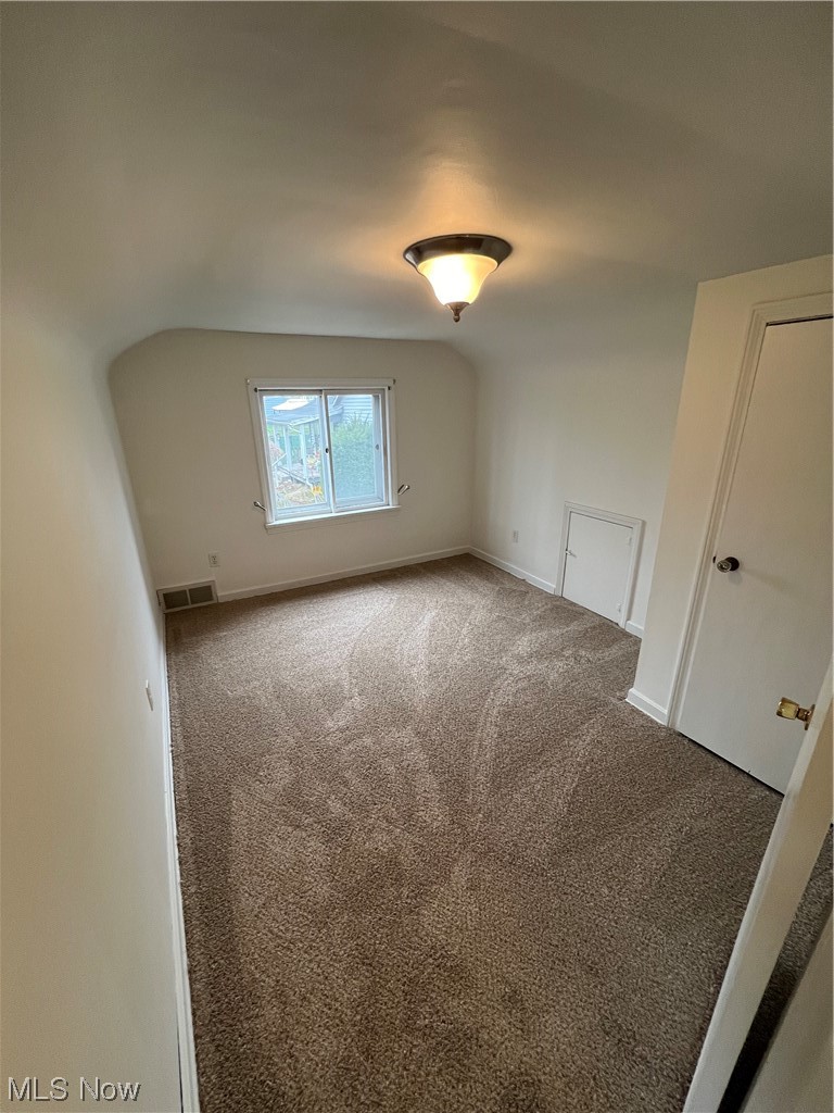 545 7th Street Struthers, OH 44471 - Photo 15 of 17 Carpeted empty room with vaulted ceiling