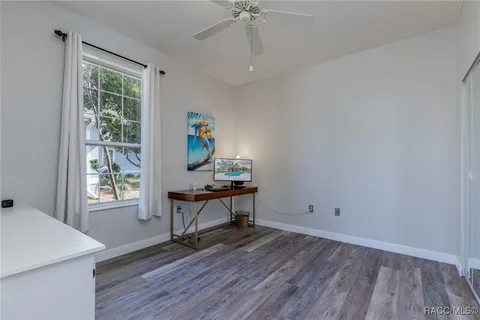 a workspace with wooden floor and a window