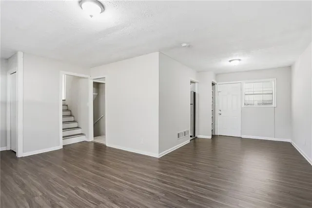 an empty room with wooden floor