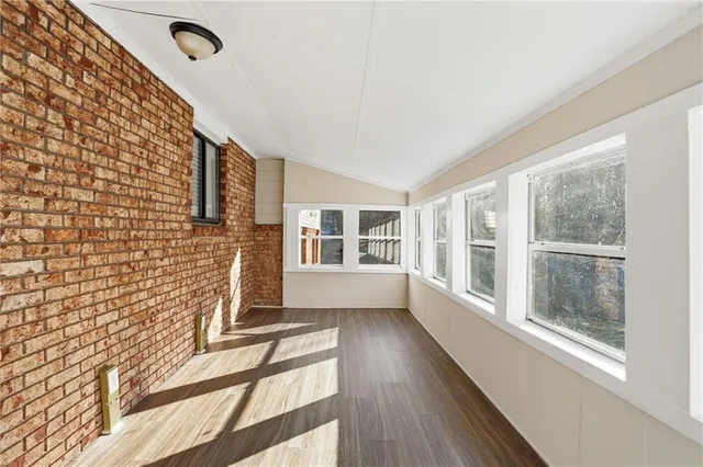 a view of a house with wooden floor and a fireplace
