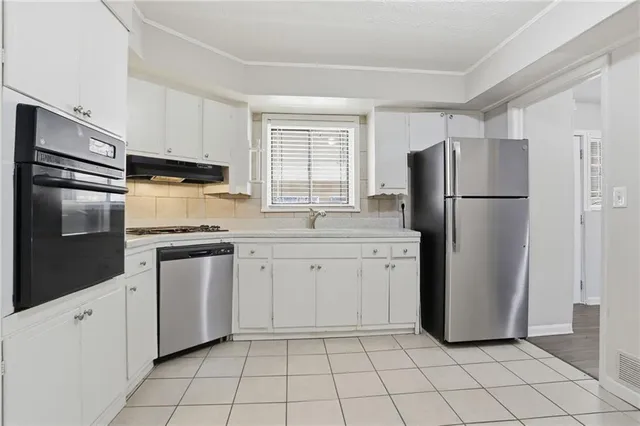 a kitchen with a refrigerator sink and microwave