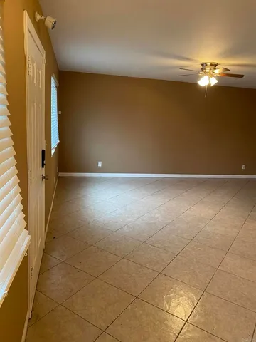a view of an empty room with a chandelier