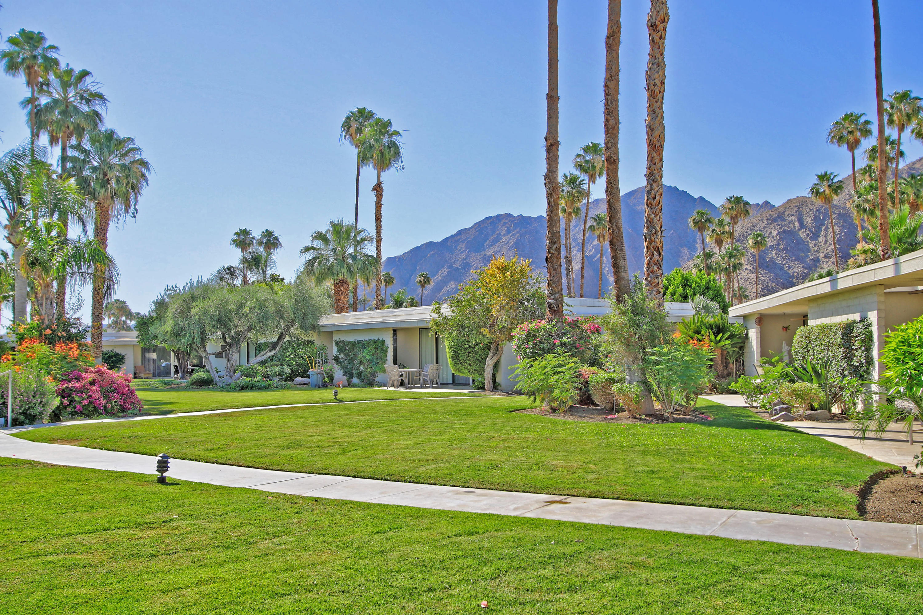 45760 Pawnee Road Indian Wells, CA 92210 - Photo 2 of 56 a front view of a house with a yard and potted plants