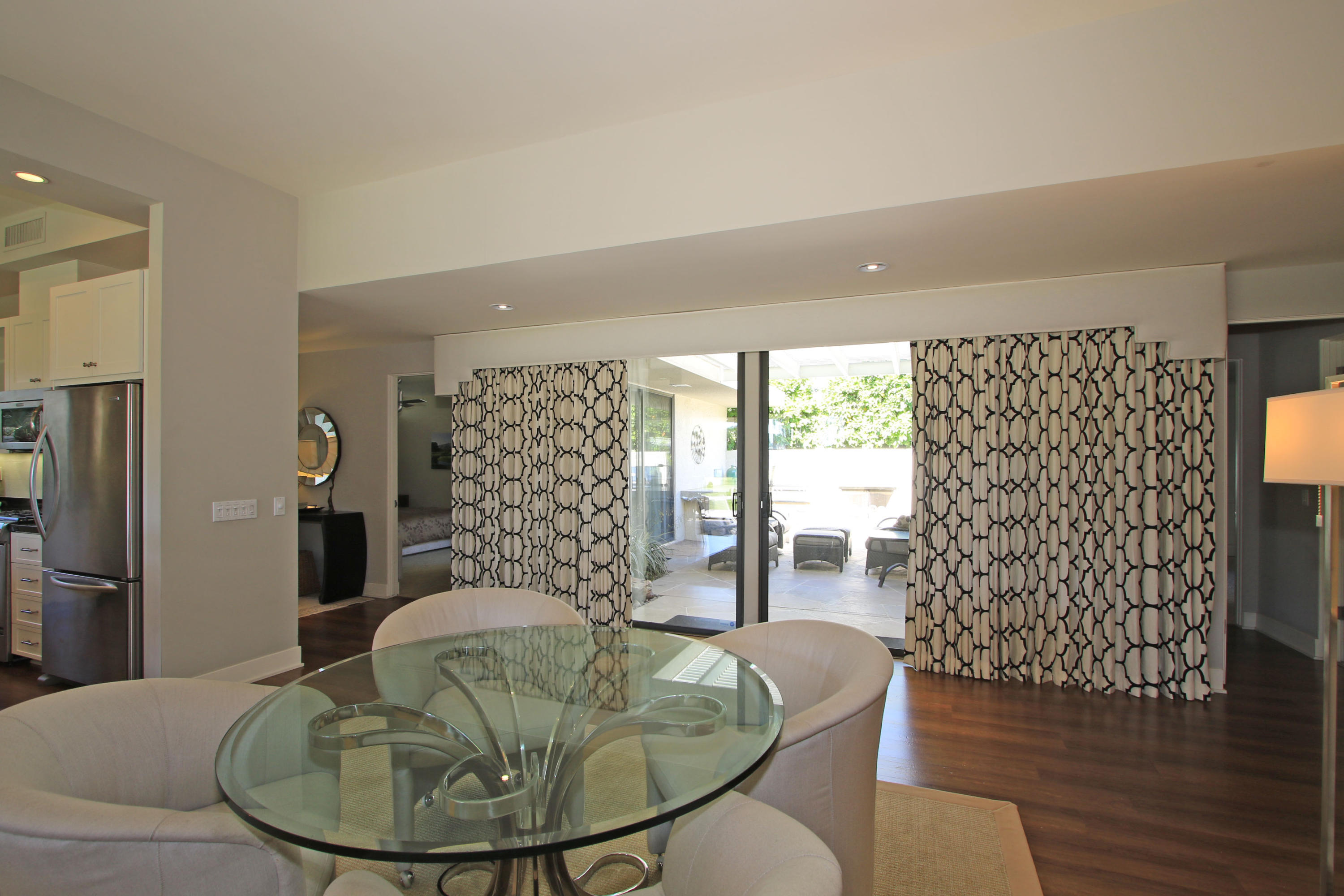 45760 Pawnee Road Indian Wells, CA 92210 - Photo 13 of 56 a dining room with furniture a chandelier and wooden floor