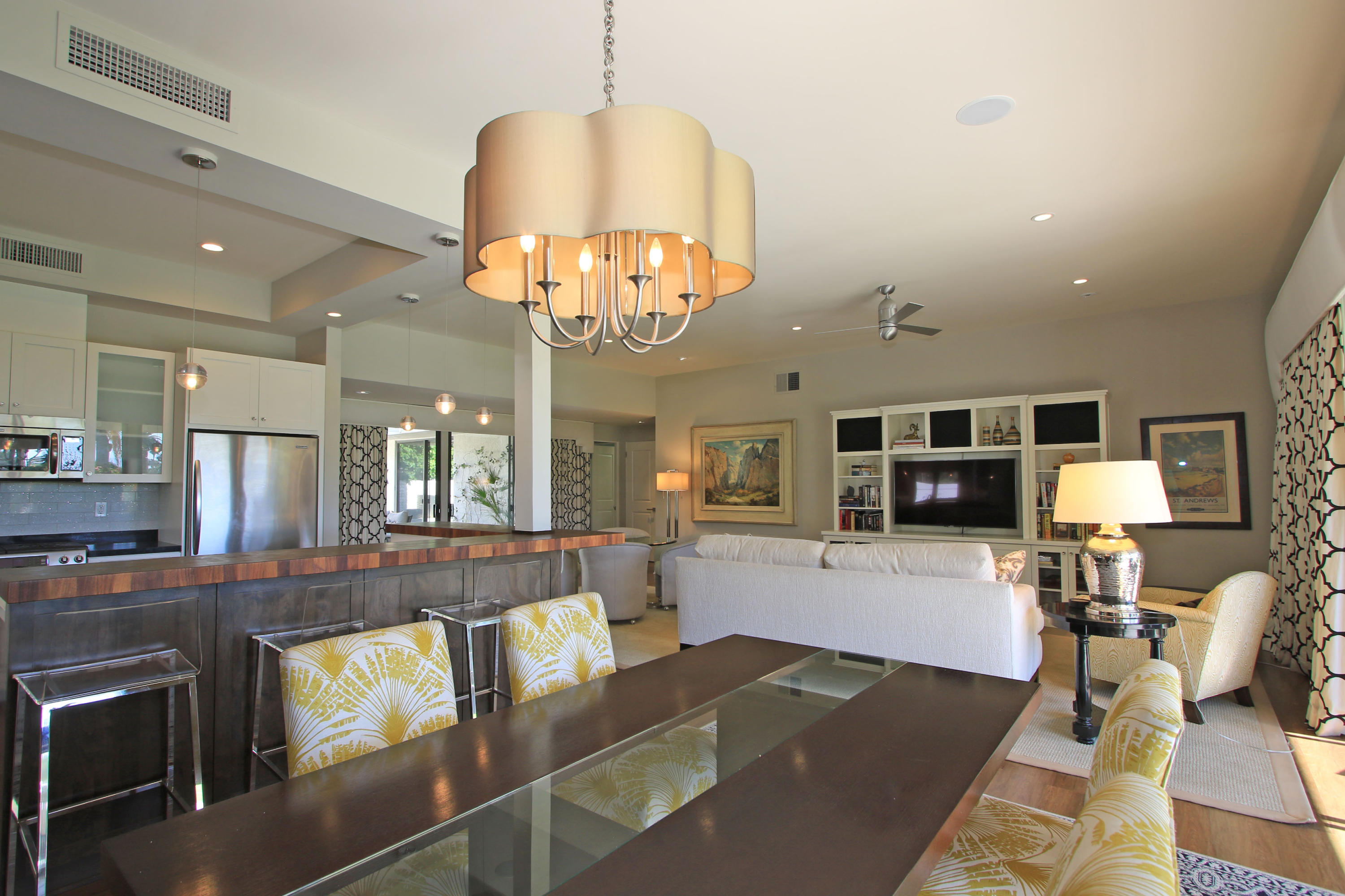 45760 Pawnee Road Indian Wells, CA 92210 - Photo 19 of 56 a living room with furniture kitchen view and a chandelier