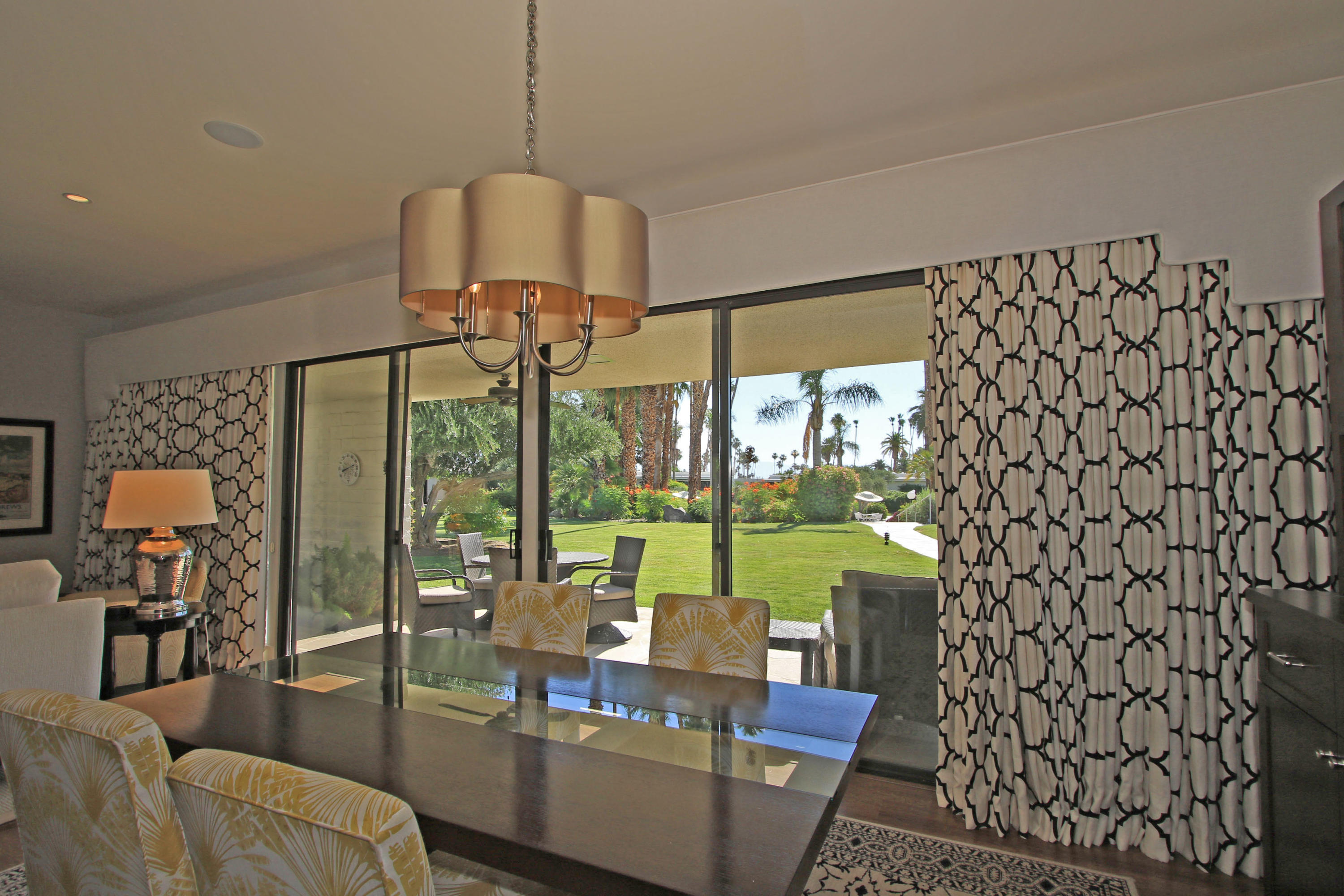 45760 Pawnee Road Indian Wells, CA 92210 - Photo 21 of 56 a living room with patio furniture and a floor to ceiling window