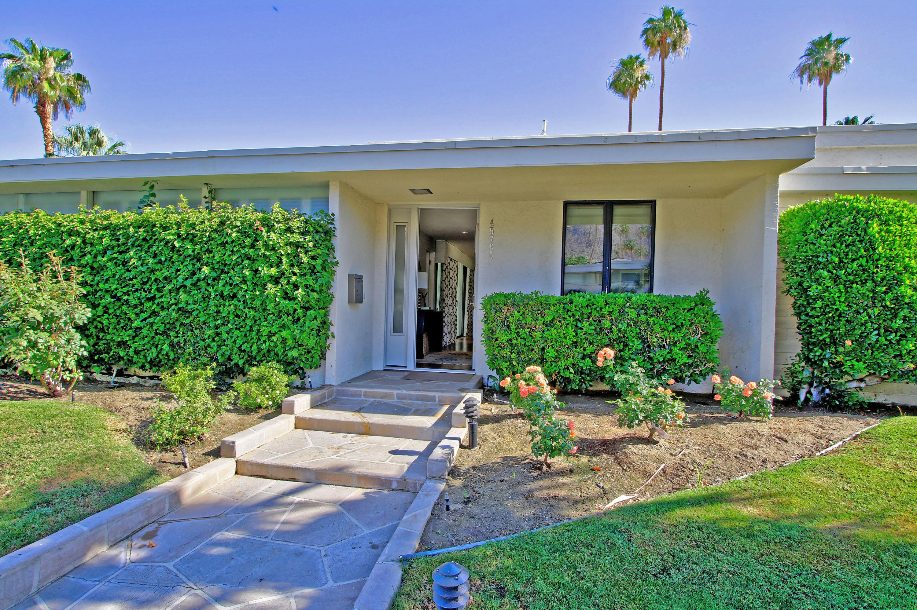 45760 Pawnee Road Indian Wells, CA 92210 - Photo 4 of 56 a front view of a house with a yard