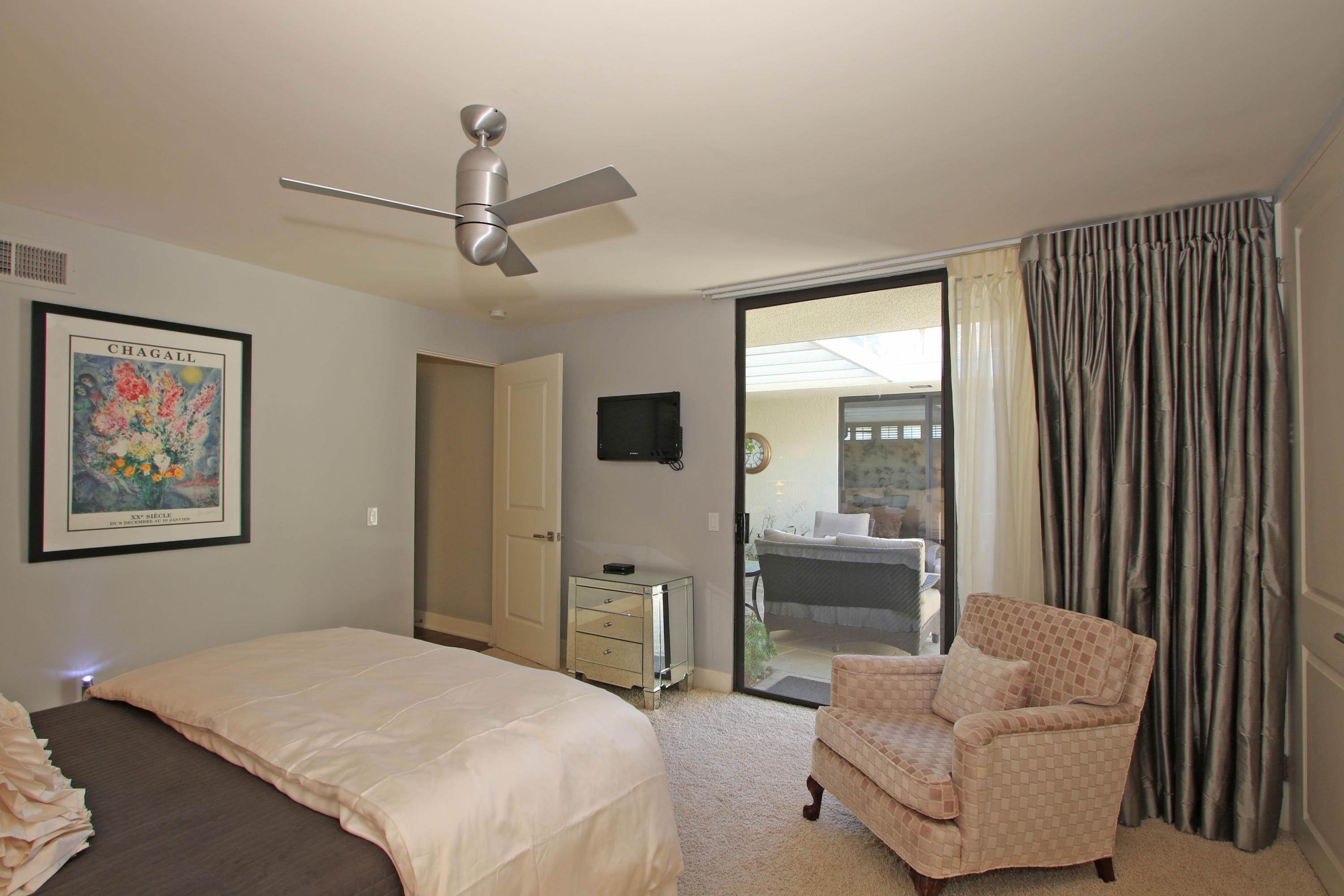 45760 Pawnee Road Indian Wells, CA 92210 - Photo 31 of 56 a bedroom with furniture and a large window
