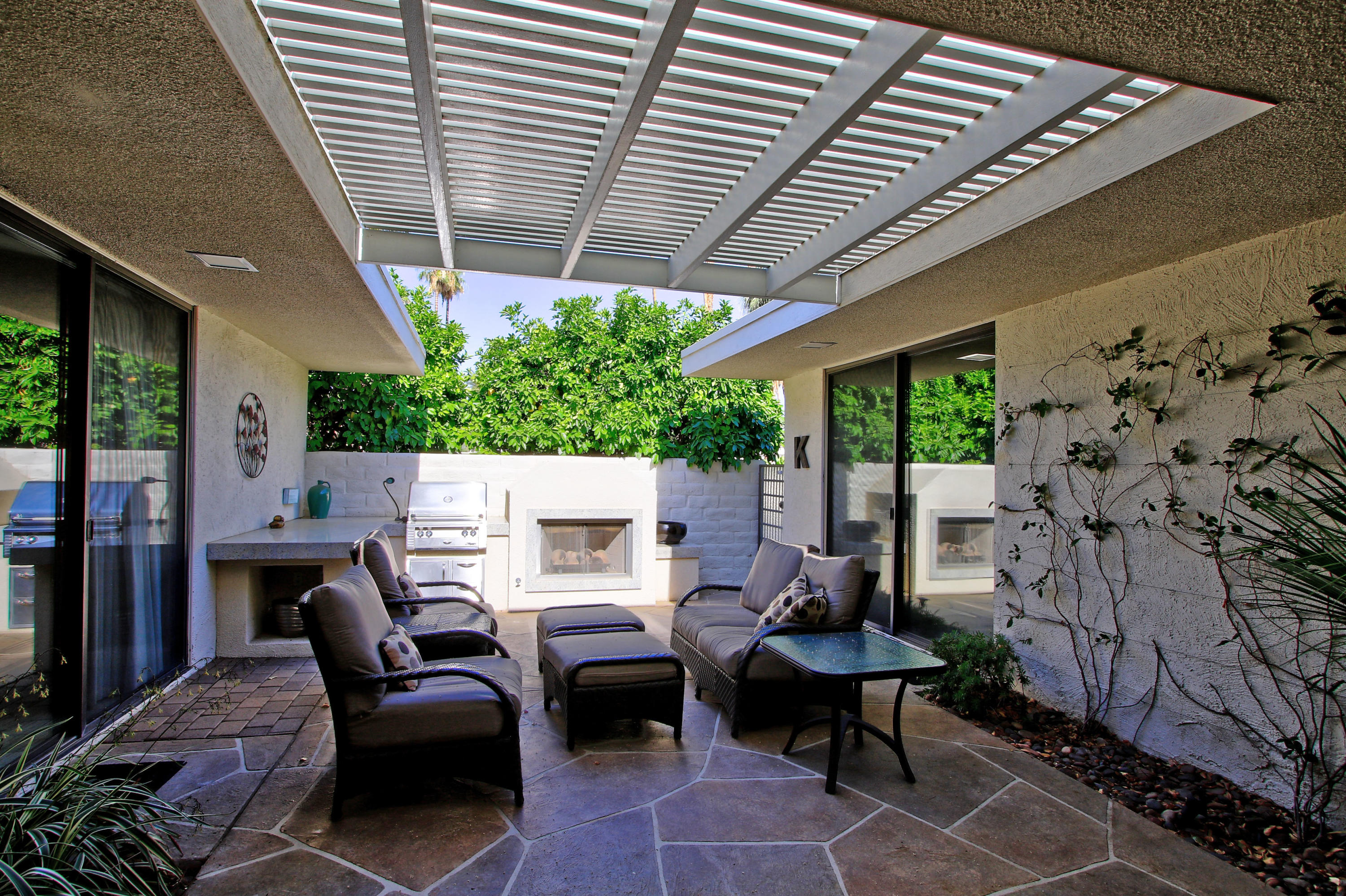 45760 Pawnee Road Indian Wells, CA 92210 - Photo 38 of 56 a view of a patio with couches table and chairs and potted plants