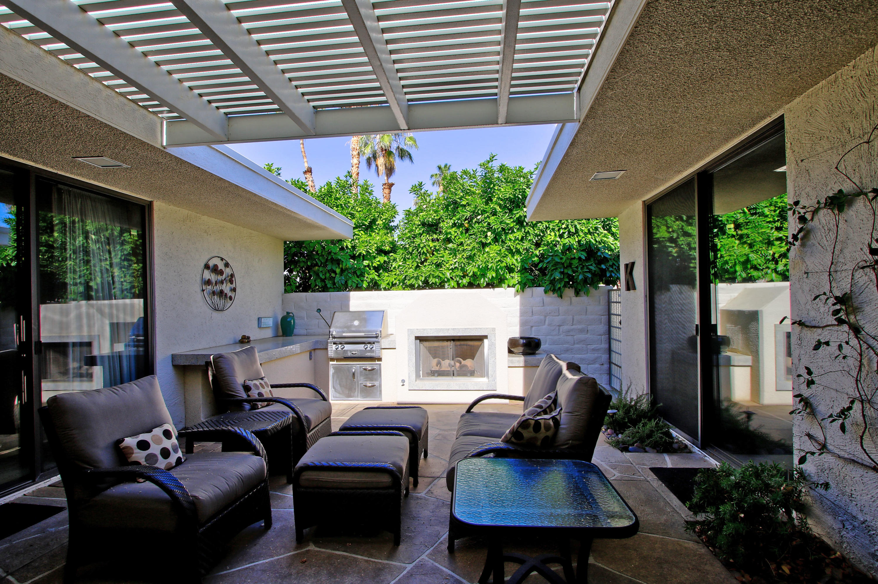 45760 Pawnee Road Indian Wells, CA 92210 - Photo 39 of 56 a view of a patio with couches chairs and a potted plant