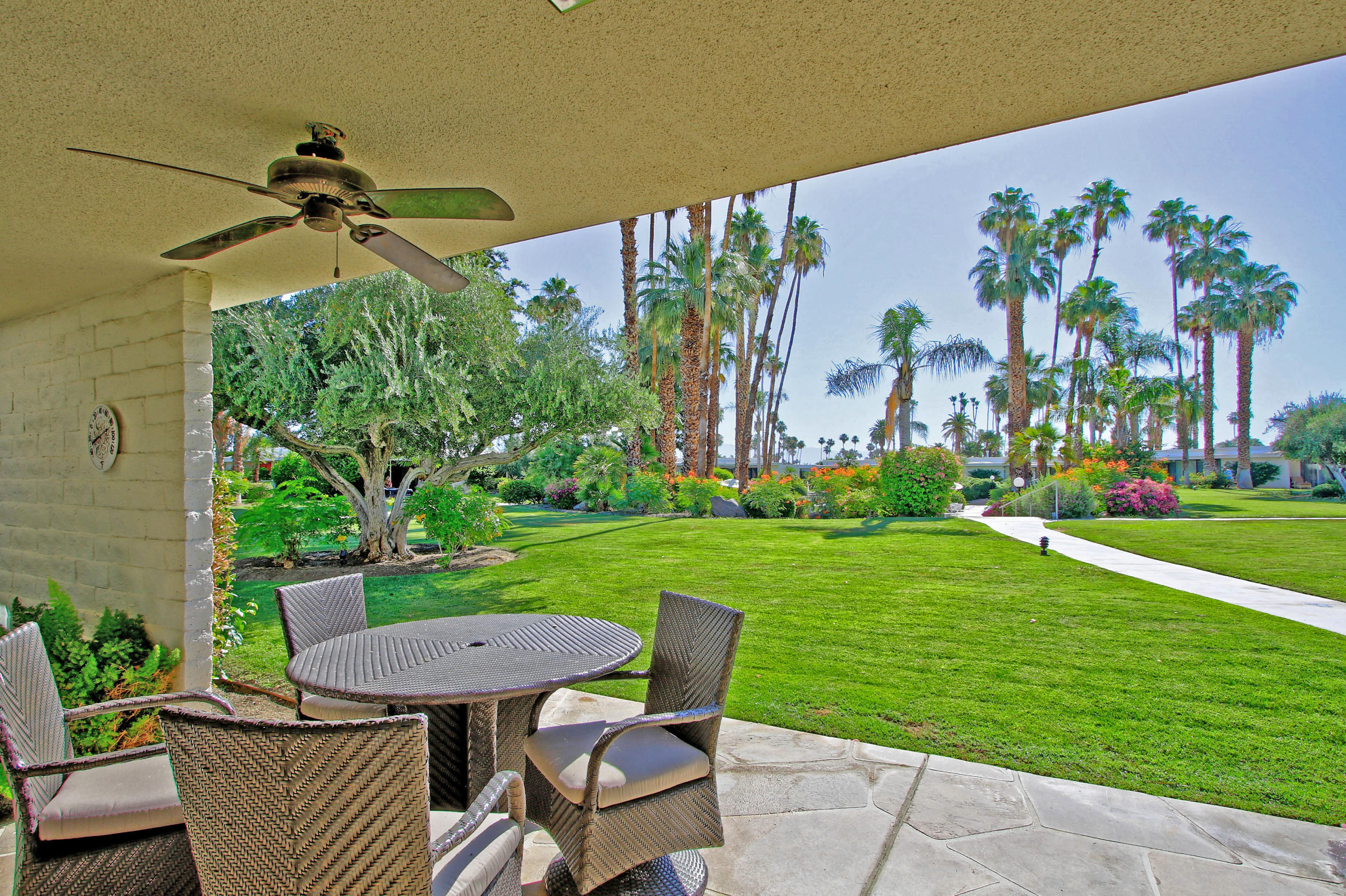 45760 Pawnee Road Indian Wells, CA 92210 - Photo 42 of 56 a view of a table and chairs in patio with a yard