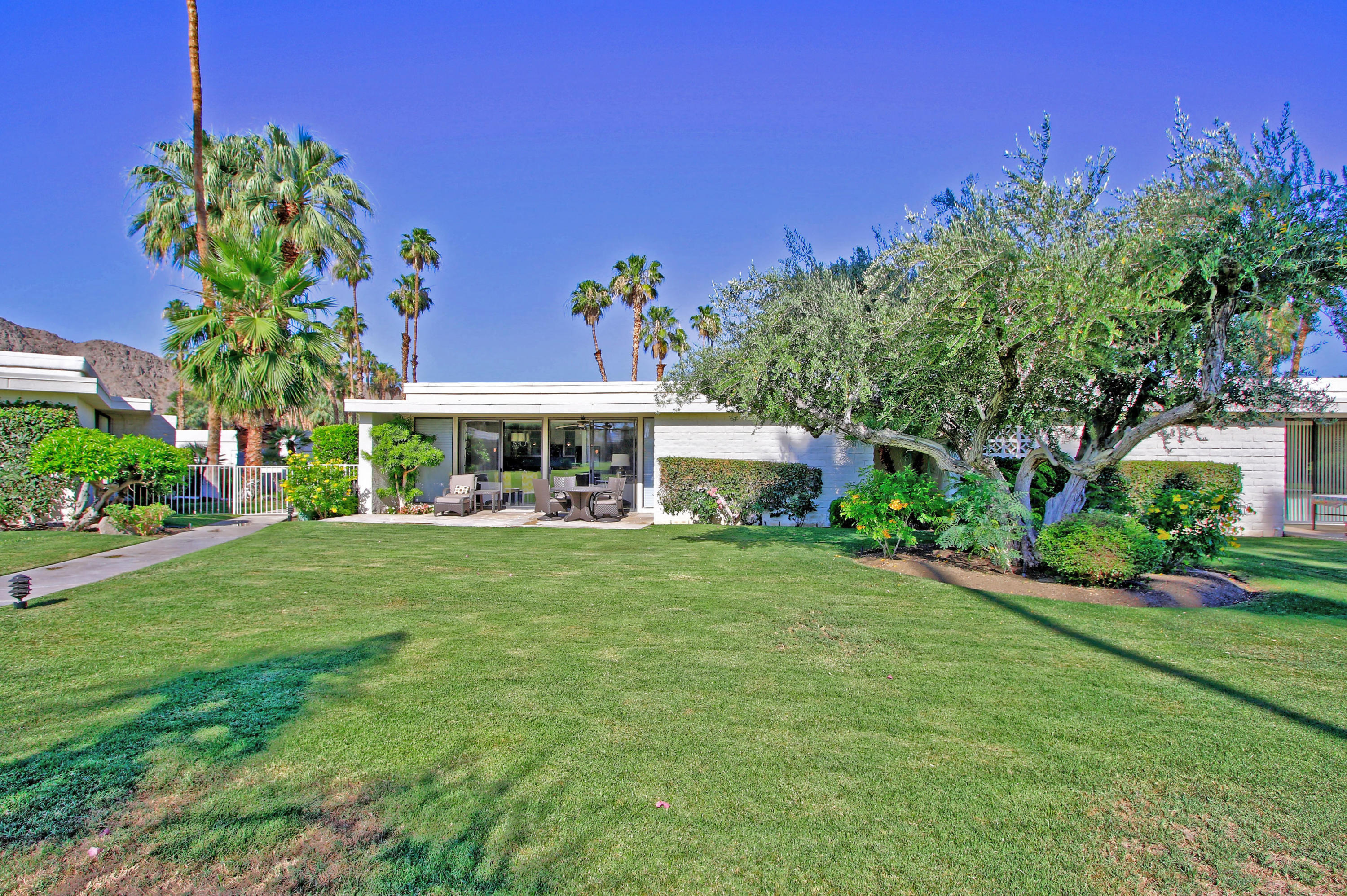 45760 Pawnee Road Indian Wells, CA 92210 - Photo 45 of 56 a front view of a house with a garden