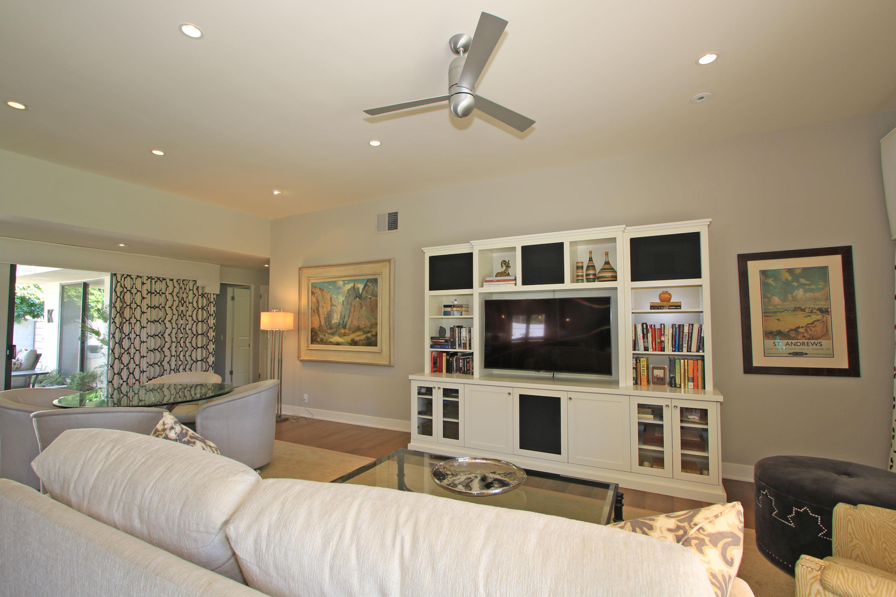 45760 Pawnee Road Indian Wells, CA 92210 - Photo 9 of 56 a living room with couches a flat screen tv and kitchen view