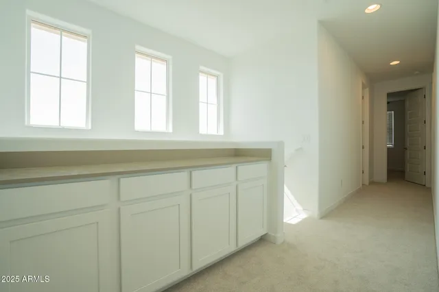 an empty room with a window and a ceiling fan