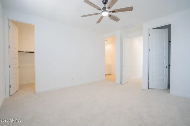 a view of empty room with ceiling fan