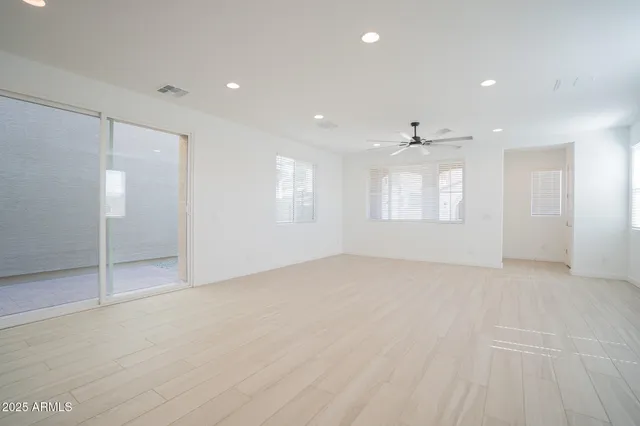 an empty room with windows and closet