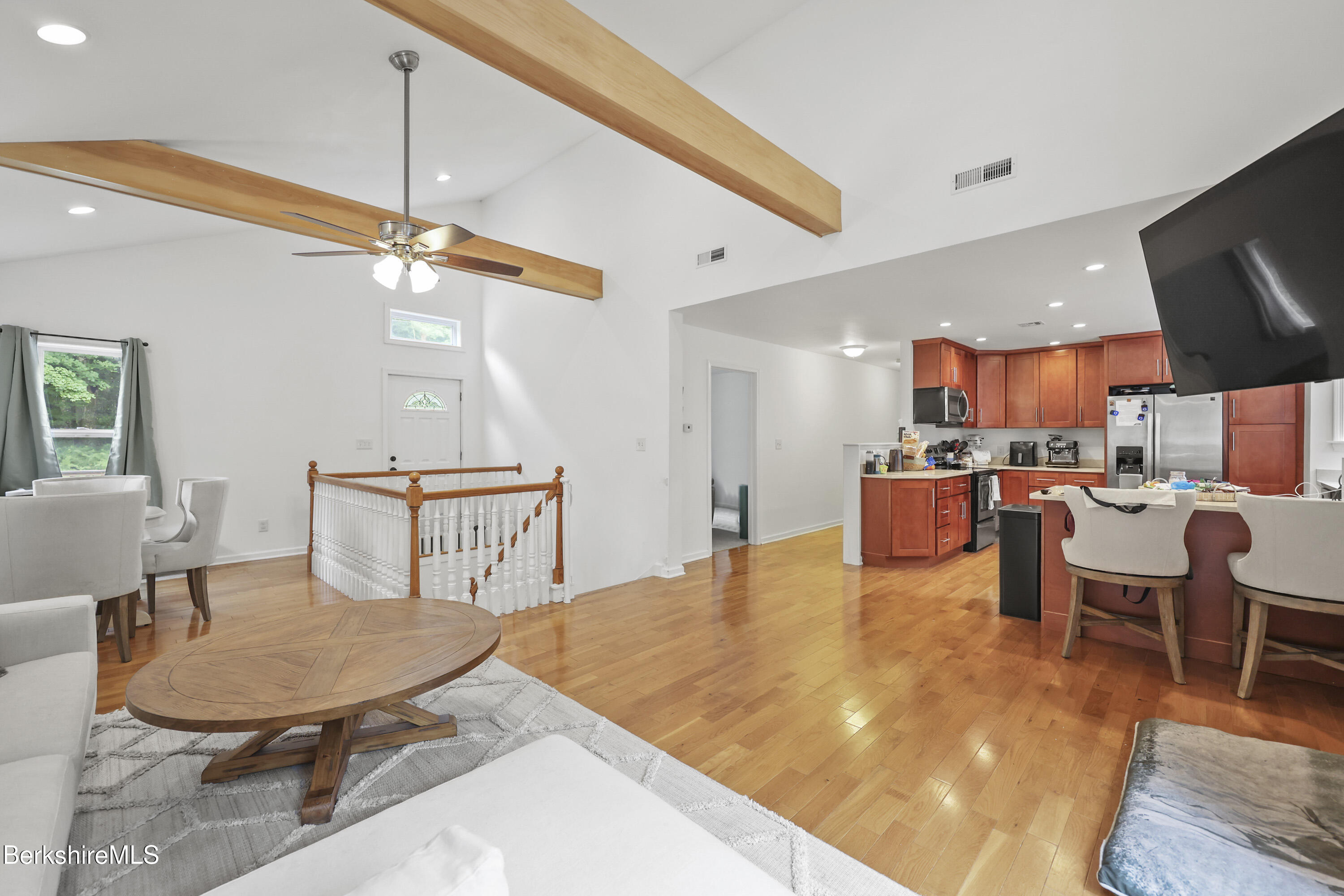 674 Benton Hill Road Becket, MA 01223 - Photo 12 of 61 a living room with kitchen island furniture and a chandelier
