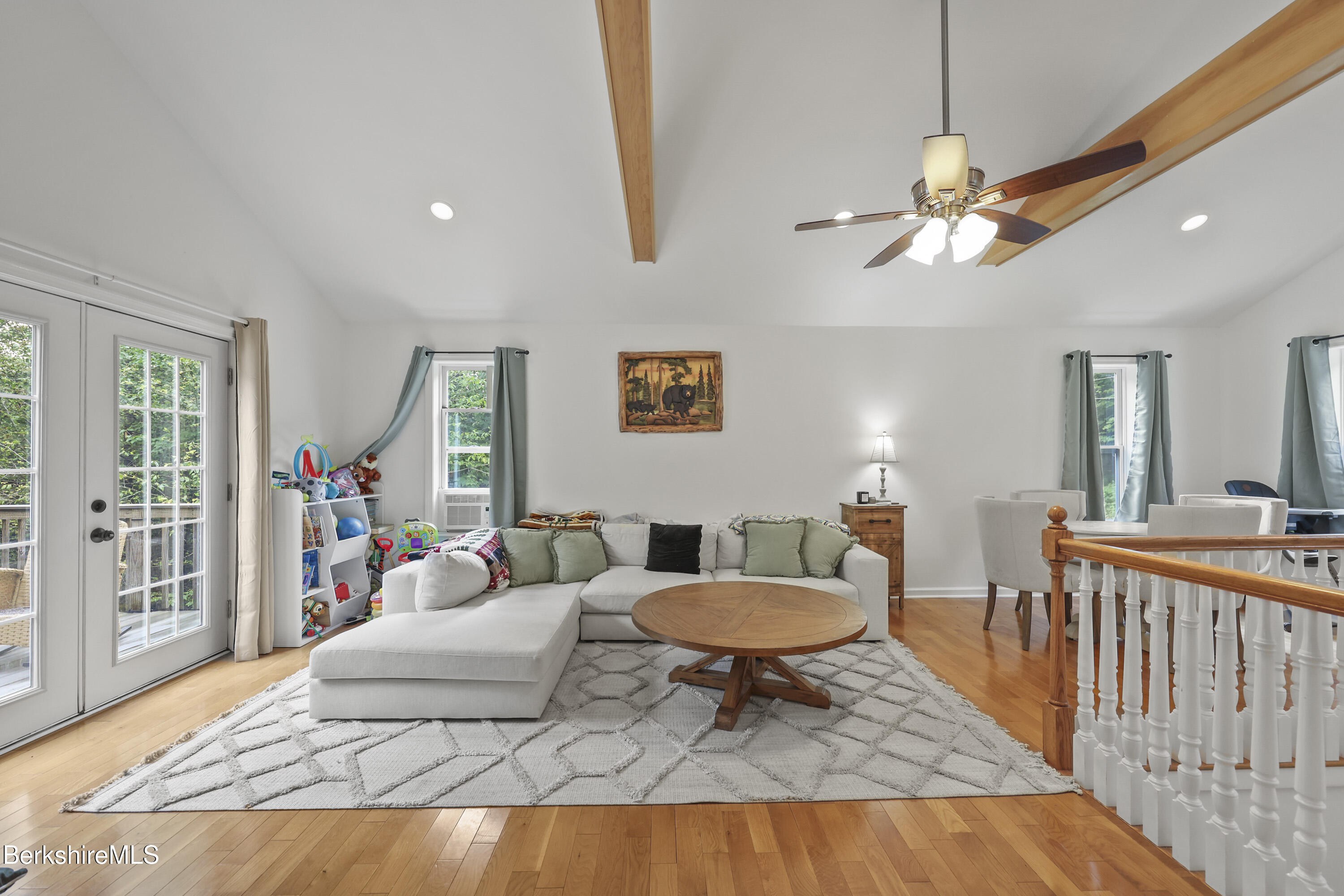 674 Benton Hill Road Becket, MA 01223 - Photo 14 of 61 a living room with furniture a rug and a chandelier