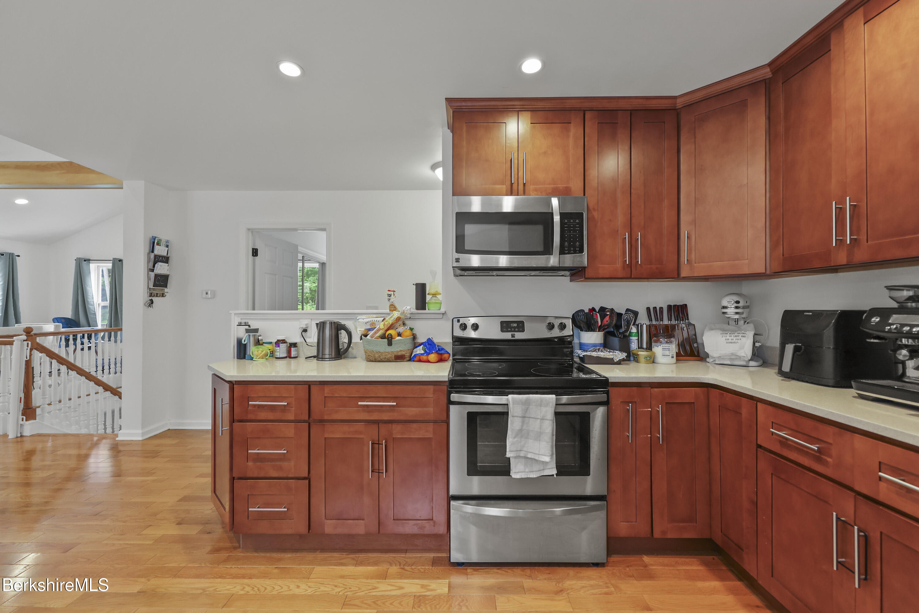 674 Benton Hill Road Becket, MA 01223 - Photo 23 of 61 a kitchen with stainless steel appliances granite countertop a stove top oven a sink dishwasher and cabinets with wooden floor