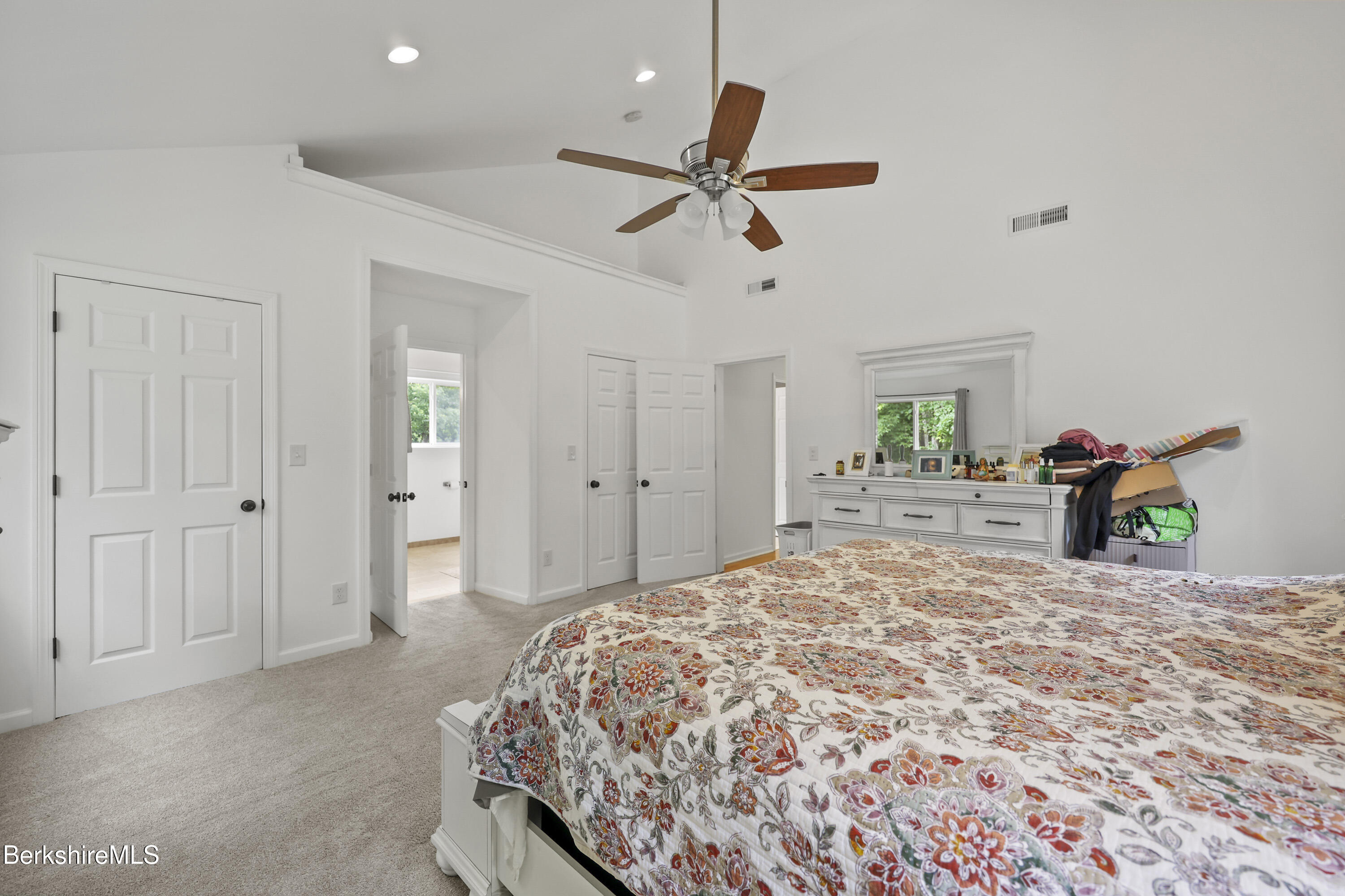 674 Benton Hill Road Becket, MA 01223 - Photo 27 of 61 a bedroom with a bed and a chandelier