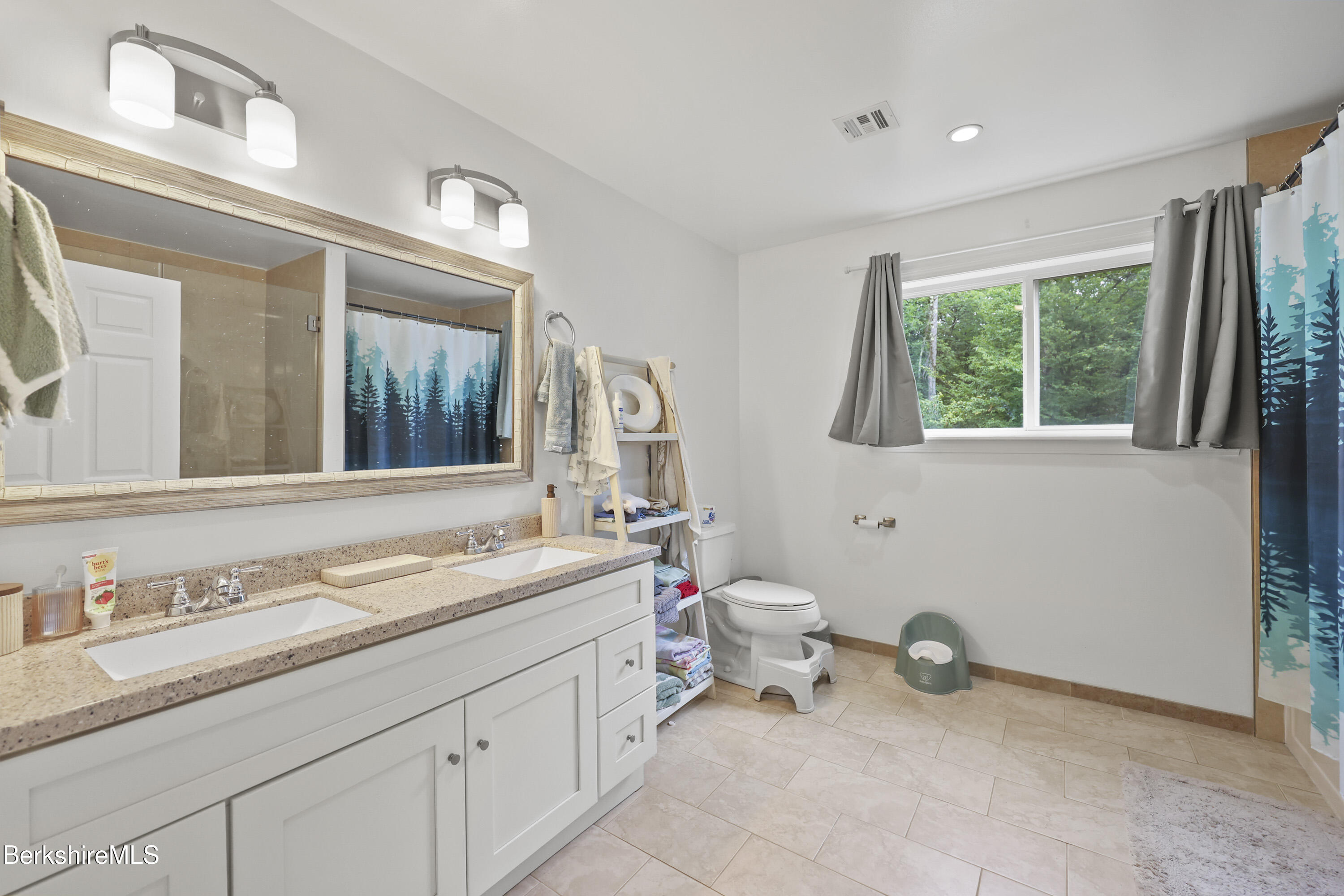 674 Benton Hill Road Becket, MA 01223 - Photo 35 of 61 a spacious bathroom with a granite countertop sink mirror and a toilet