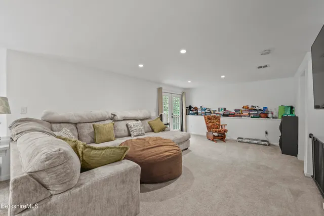 a bathroom with a toilet sink vanity and mirror