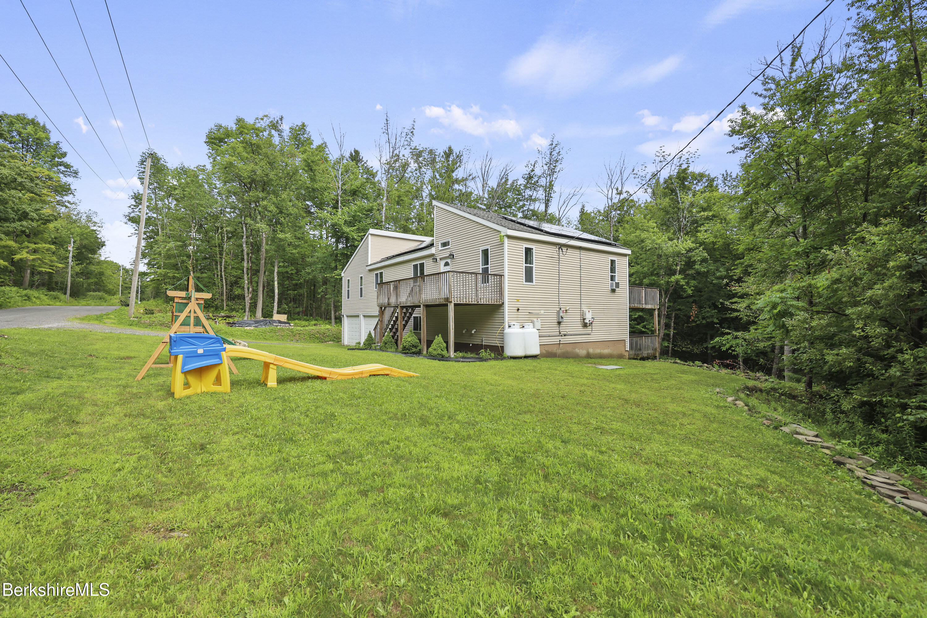 674 Benton Hill Road Becket, MA 01223 - Photo 5 of 61 a view of a house with a yard and sitting area