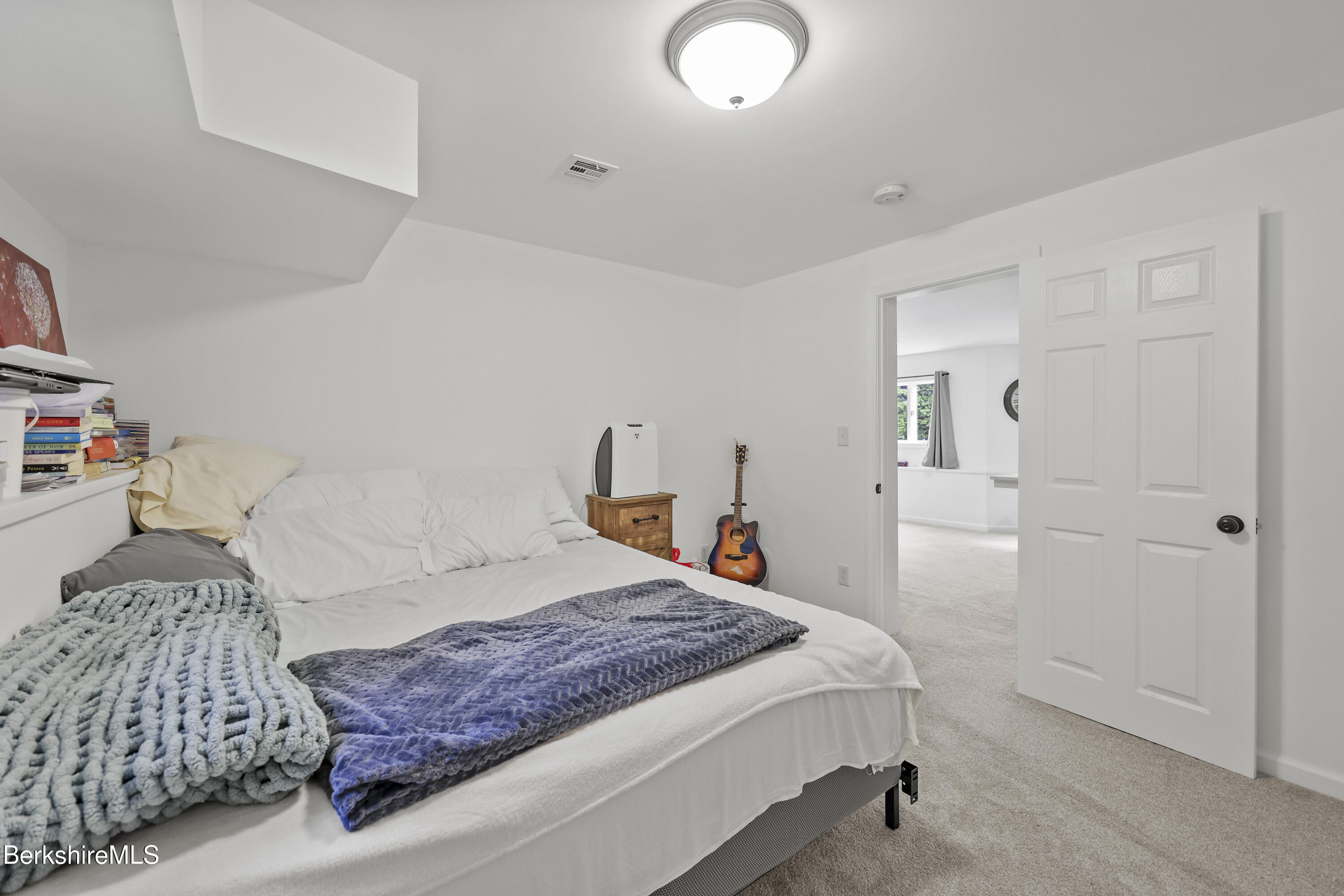 674 Benton Hill Road Becket, MA 01223 - Photo 52 of 61 a bedroom with a bed and a walk in closet