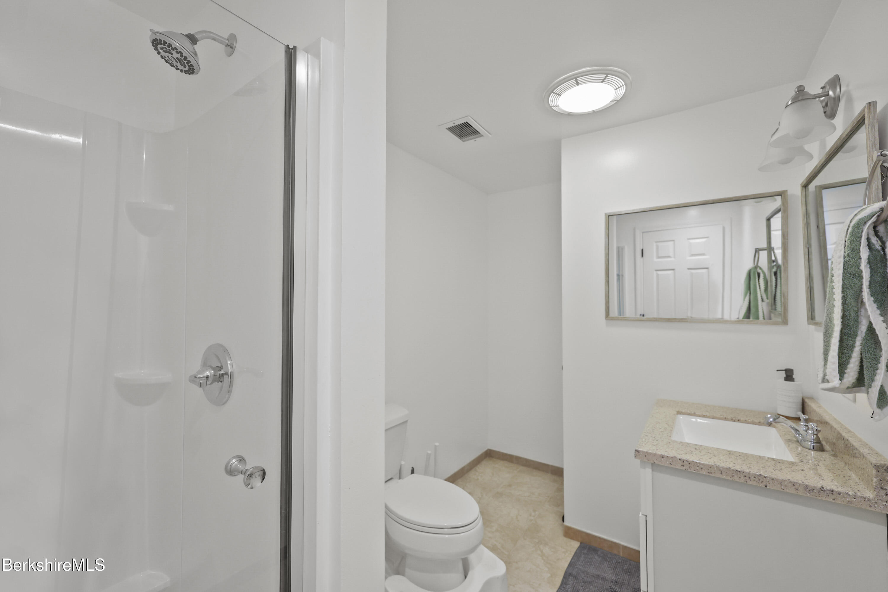 674 Benton Hill Road Becket, MA 01223 - Photo 53 of 61 a bathroom with a granite countertop sink a toilet and a mirror