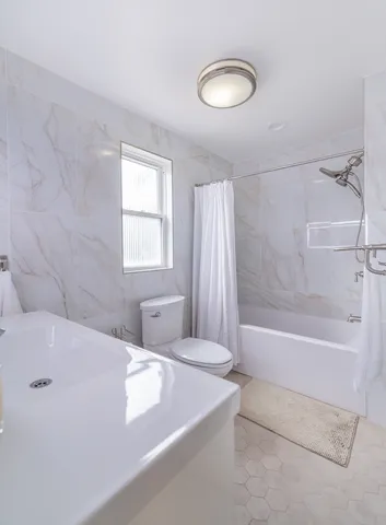a bathroom with a bathtub and a shower