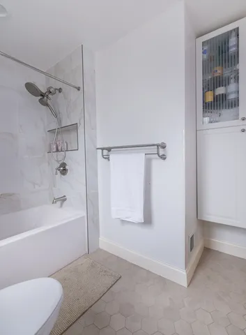 a bathroom with a bathtub and a shower