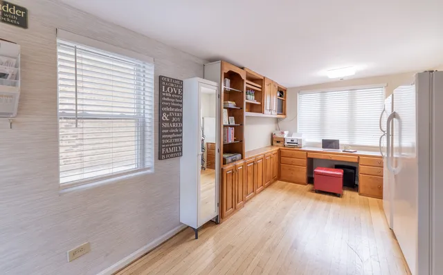 a kitchen with stainless steel appliances a refrigerator and a wooden floor