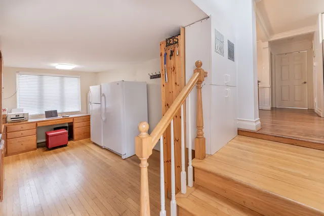 a view of a room with wooden floor and stairs