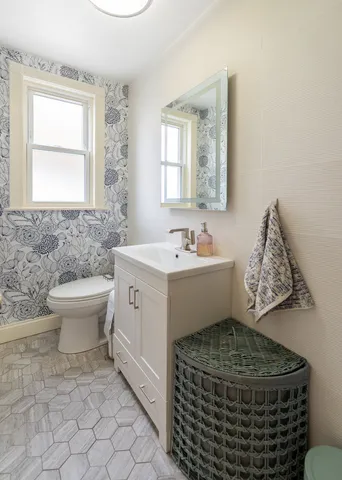 a bathroom with a sink toilet and mirror