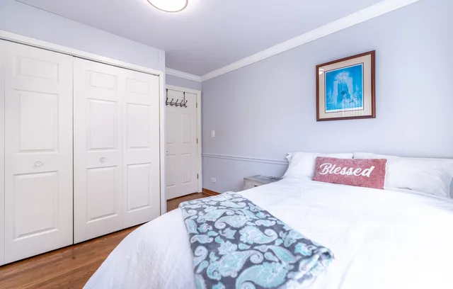 a bedroom with a bed and a painting on the wall