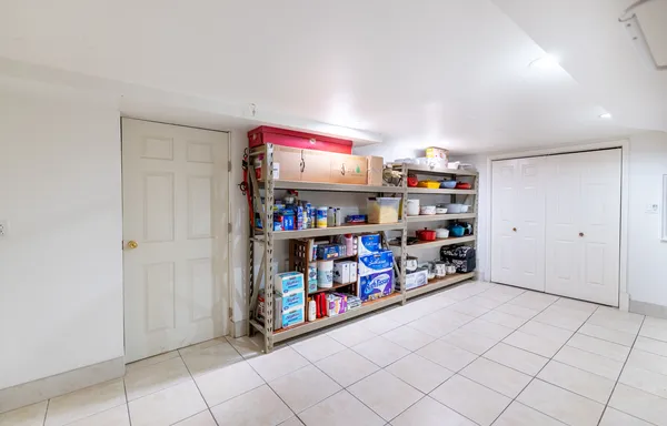 a room with storage and a white cabinets
