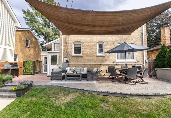 a swimming pool with outdoor seating and yard