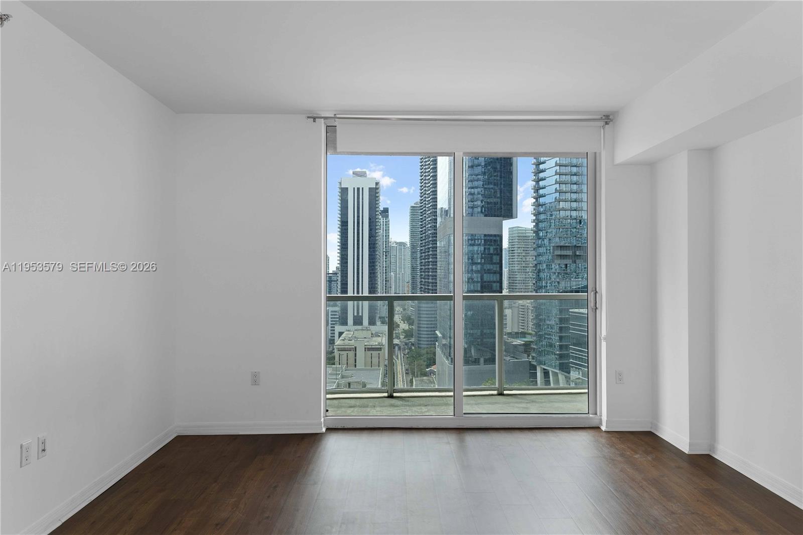 55 Southeast 6th Street, Unit 2606 Miami, FL 33131 - Photo 11 of 18 a view of wooden floor and windows in a room