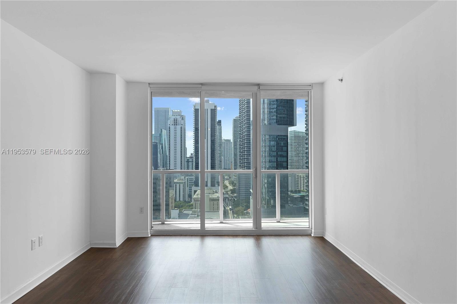 55 Southeast 6th Street, Unit 2606 Miami, FL 33131 - Photo 2 of 18 wooden floor in an empty room with a window