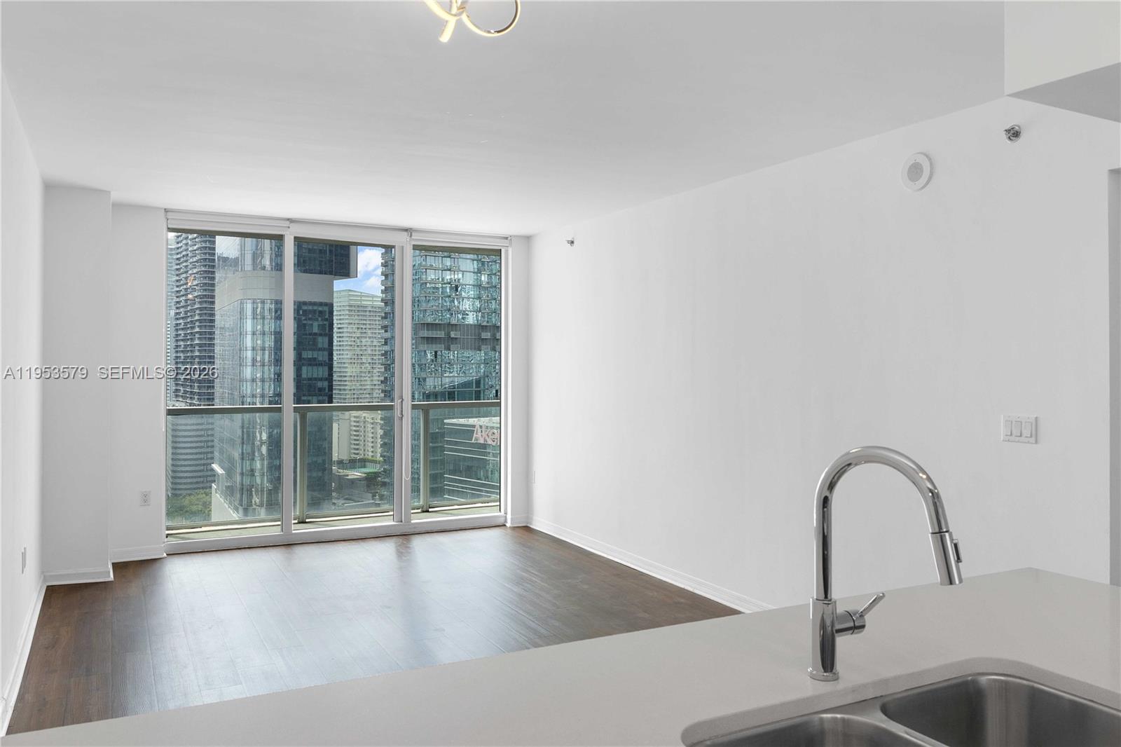 55 Southeast 6th Street, Unit 2606 Miami, FL 33131 - Photo 4 of 18 a view of a room with a sink and large window