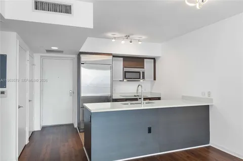 a bathroom with a sink a large mirror and shower